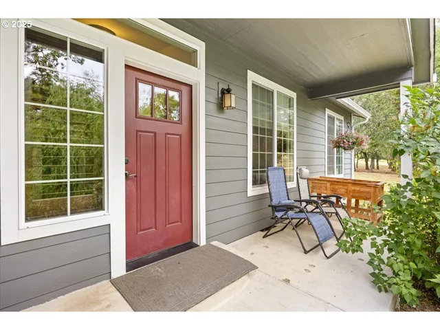 a view of a porch with a table and chairs