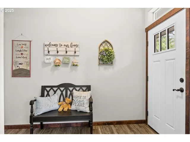 a view of a bedroom with baby crib and hanging chair