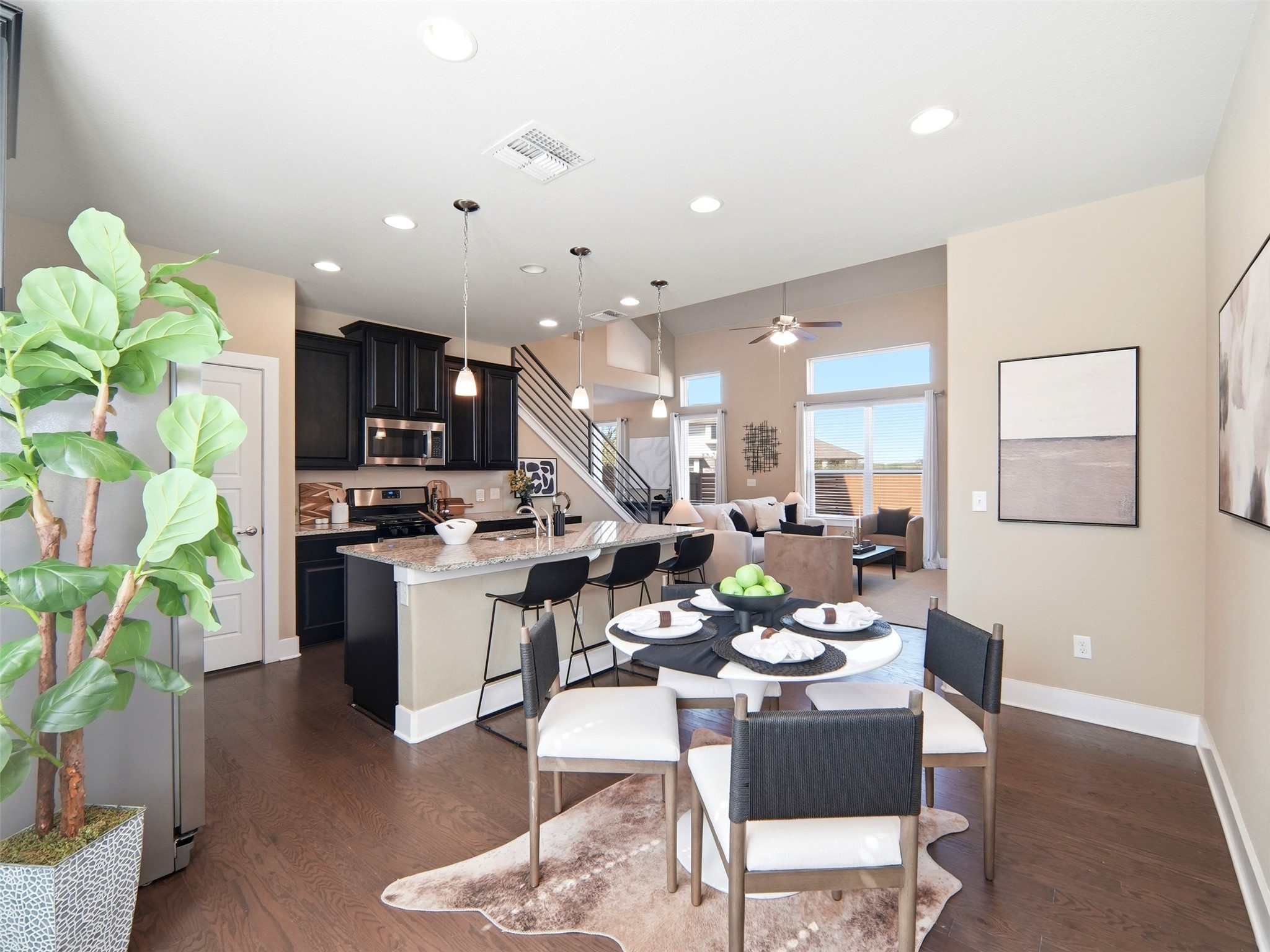 6916 Cardinal Bloom Loop Austin, TX 78744 - Photo 10 of 37 a kitchen with a table and chairs in it