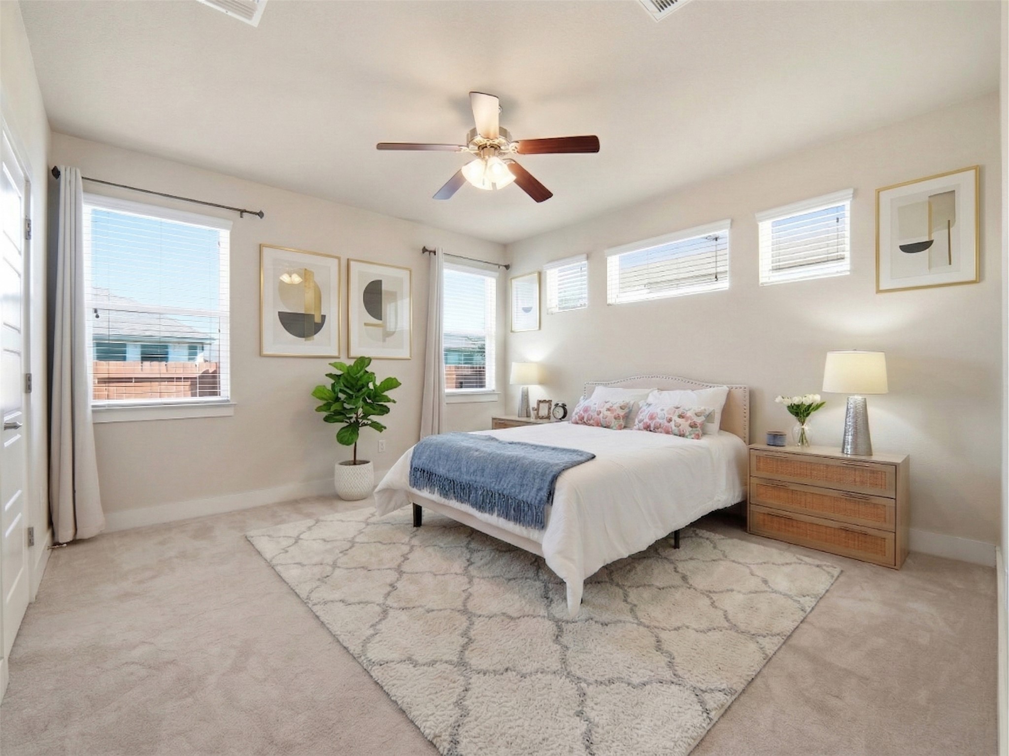 6916 Cardinal Bloom Loop Austin, TX 78744 - Photo 11 of 37 a bedroom with a large bed and a chandelier