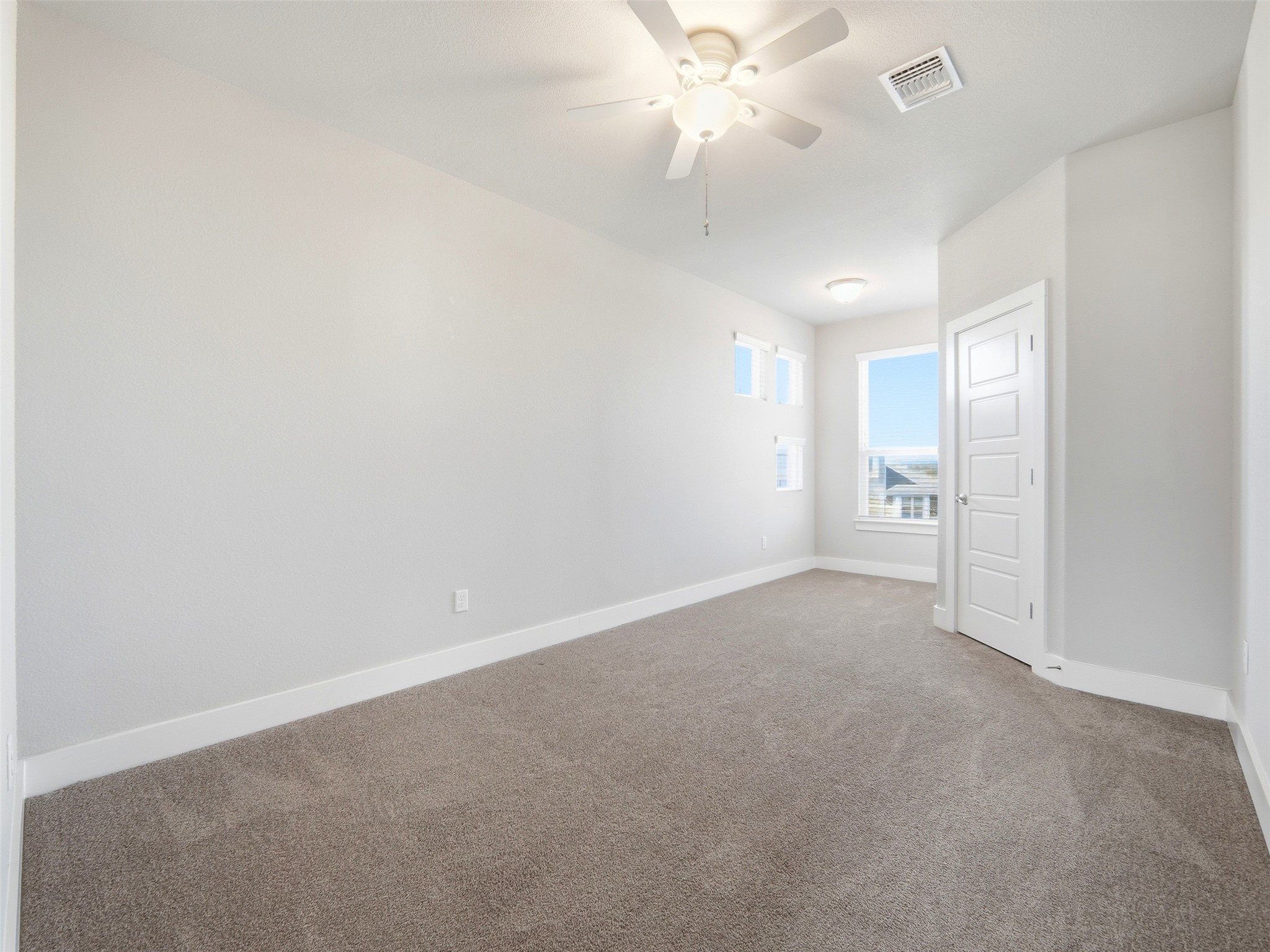 6916 Cardinal Bloom Loop Austin, TX 78744 - Photo 18 of 37 an empty room with a ceiling fan and a fan