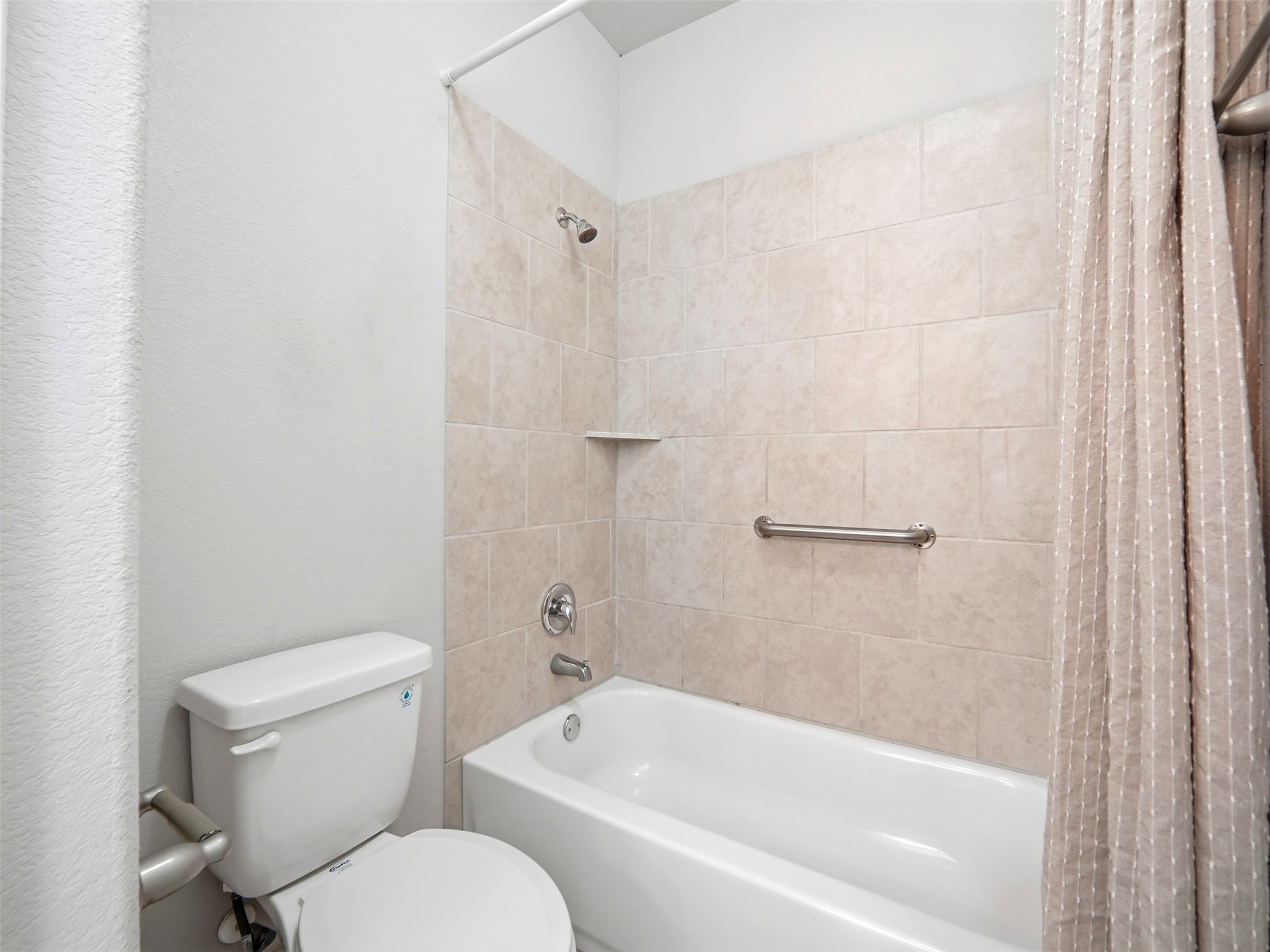 6916 Cardinal Bloom Loop Austin, TX 78744 - Photo 22 of 37 a white toilet sitting next to a bath tub