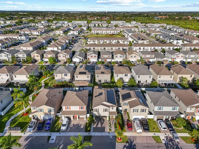 an aerial view of residential houses with outdoor space