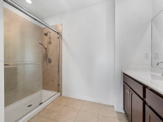 a bathroom with a shower and a sink