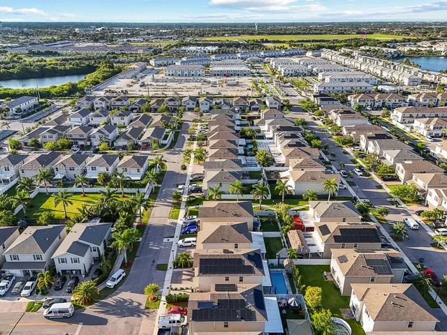 an aerial view of residential houses with outdoor space