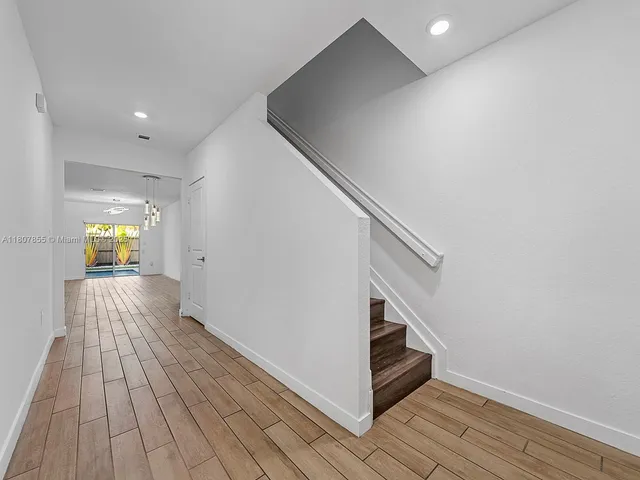 a view of hallway with wooden floor