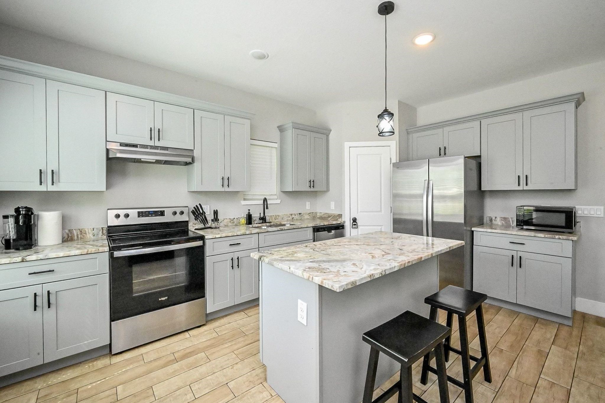5007 Briscoe Street, Unit A Houston, TX 77033 - Photo 3 of 16 Open Concept Kitchen with Granite Countertops and Stainless Steel Appliances