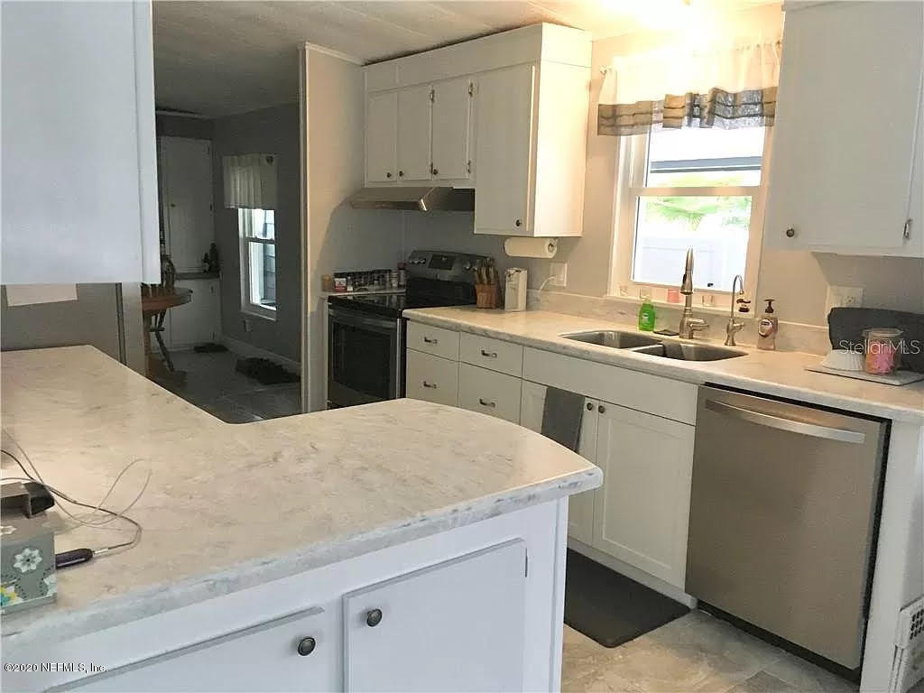 133 Bayou Drive Satsuma, FL 32189 - Photo 11 of 30 a kitchen with a sink stove and refrigerator