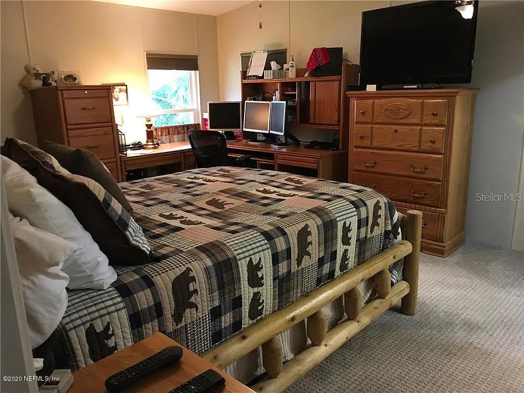 133 Bayou Drive Satsuma, FL 32189 - Photo 16 of 30 a bedroom with a bed and flat screen tv