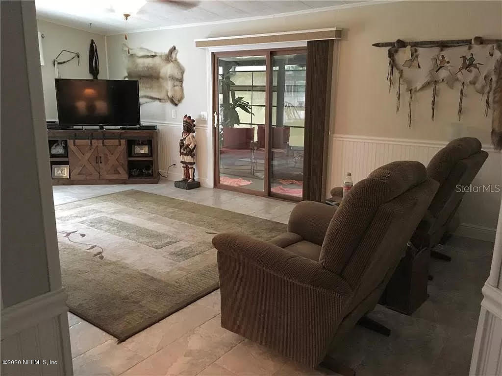 133 Bayou Drive Satsuma, FL 32189 - Photo 6 of 30 a living room with furniture and a flat screen tv