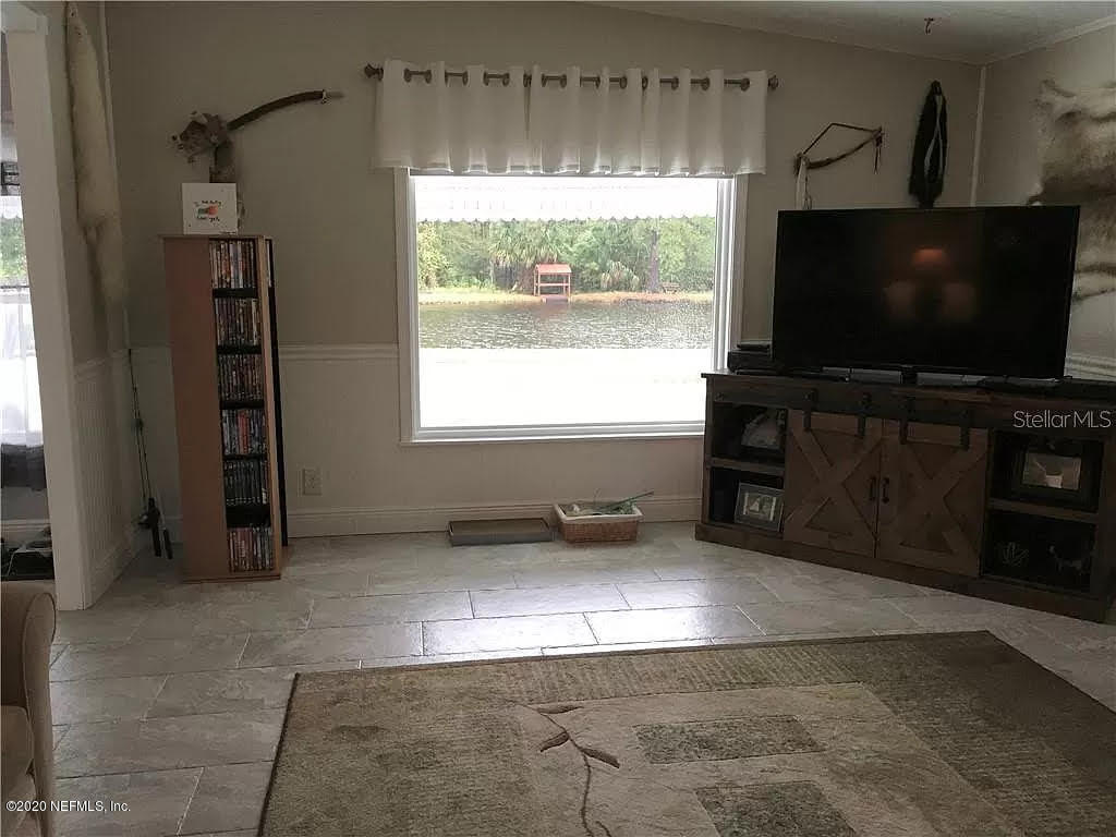133 Bayou Drive Satsuma, FL 32189 - Photo 7 of 30 a living room with furniture and a flat screen tv