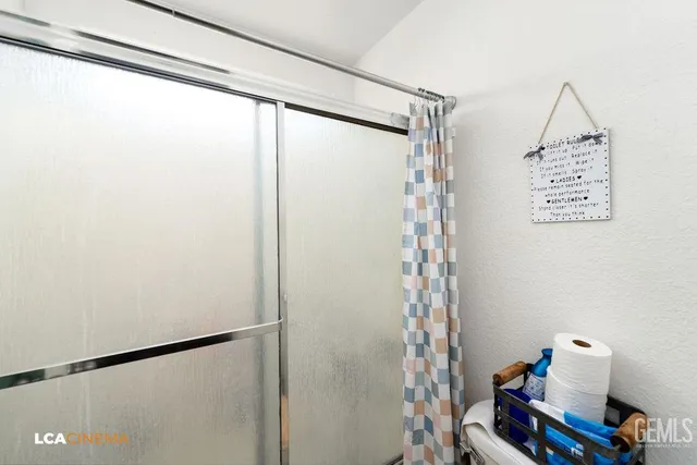 a bathroom with a shower and a sink