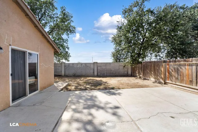 a view of wooden fence and trees around
