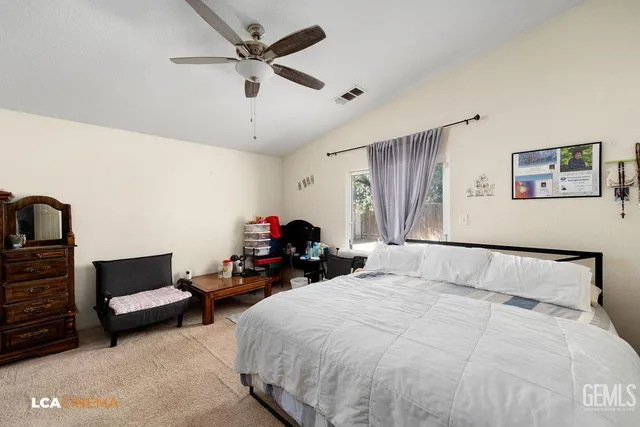 a bedroom with bed and a ceiling fan