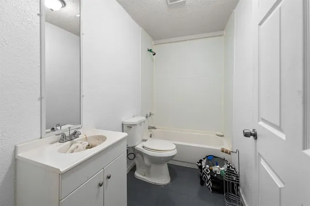 a bathroom with a sink toilet and a mirror
