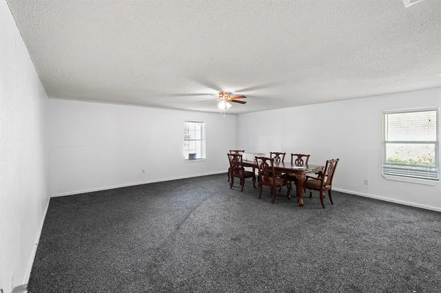 a view of a livingroom with furniture and a ceiling fan