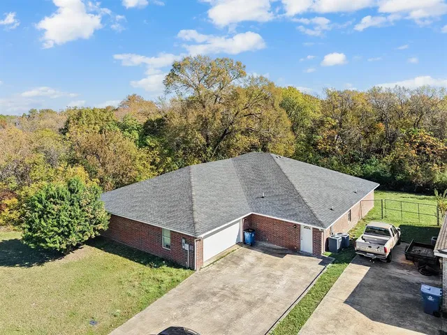 a view of a big house with a mountain in the background