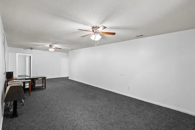 an empty room with table and chairs