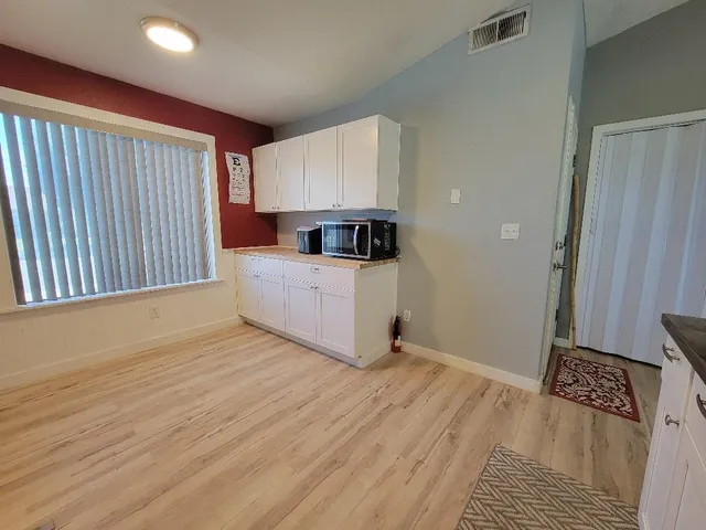 a view of kitchen and wooden floor