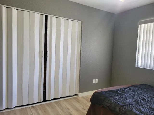a bedroom with a bed and a window