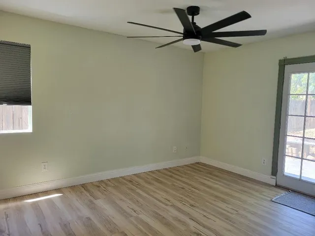 wooden floor in an empty room with a window