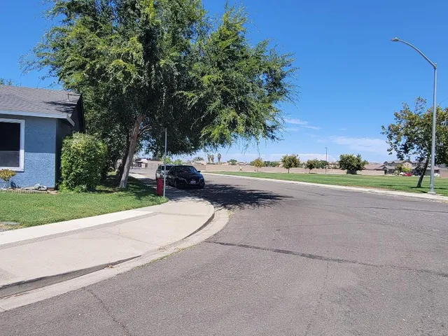 front view of a house with a yard and potted plants