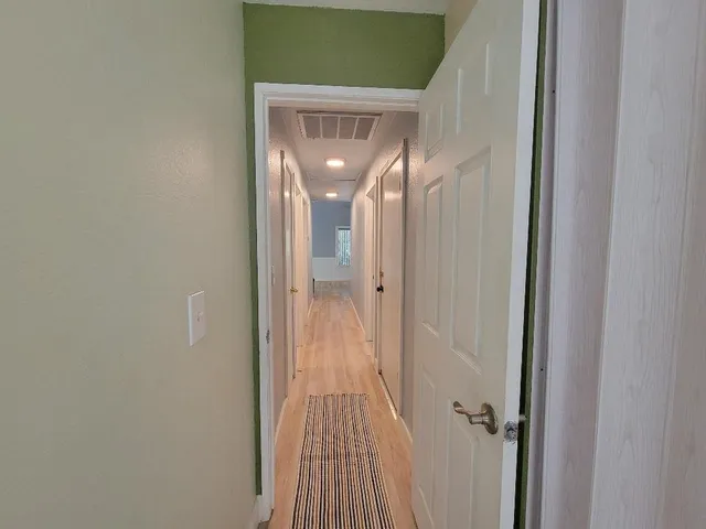 a view of a bathroom from a hallway