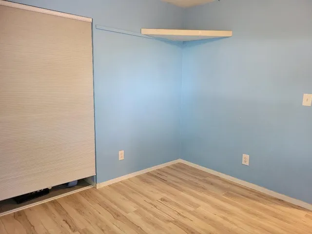 a view of a room with an empty space and a sink