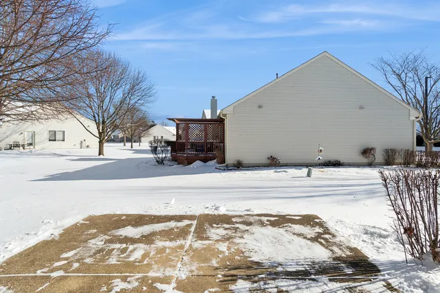 a view of a house with a snow on the road
