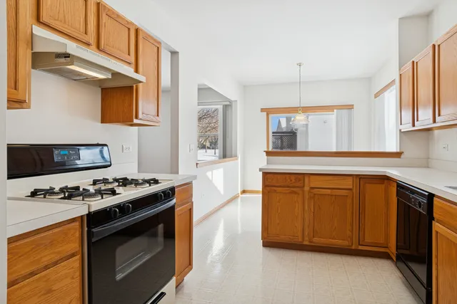 a kitchen with stainless steel appliances granite countertop a stove and a sink