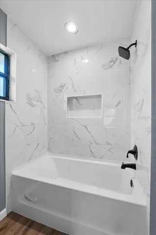 a bathroom with a bathtub and a shower