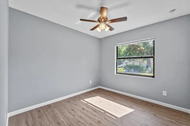 wooden floor in an empty room with a window