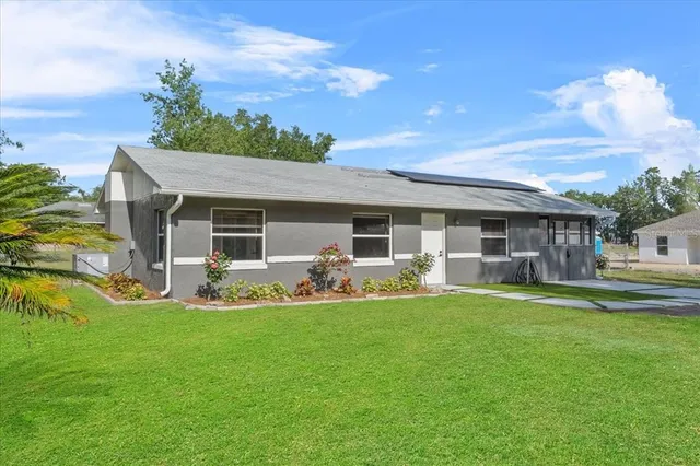 a front view of house with yard patio and green space