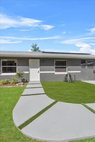 a front view of house with yard and outdoor seating