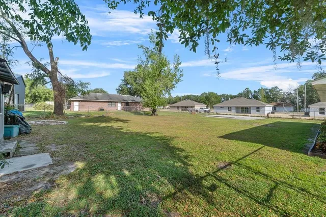 a view of a garden with a building in the background