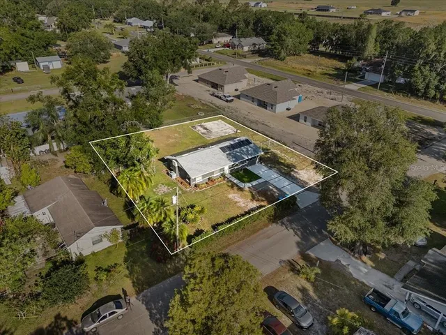 an aerial view of a house with a yard