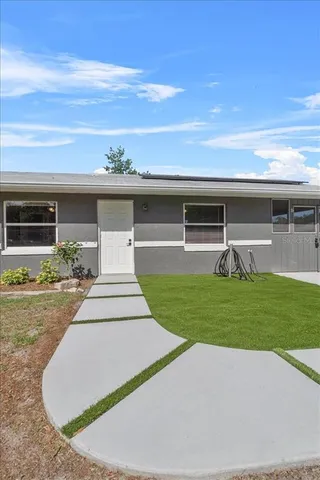 a front view of house with yard and outdoor seating