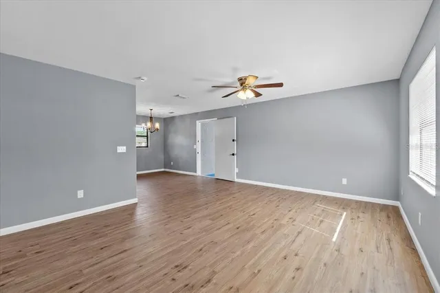 wooden floor in an empty room with a window