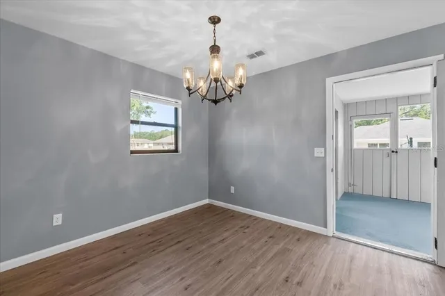 a view of a chandelier fan and wooden floor