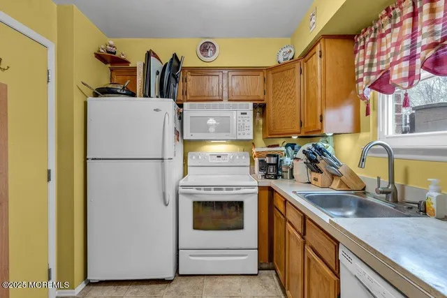 a kitchen with a refrigerator and a sink