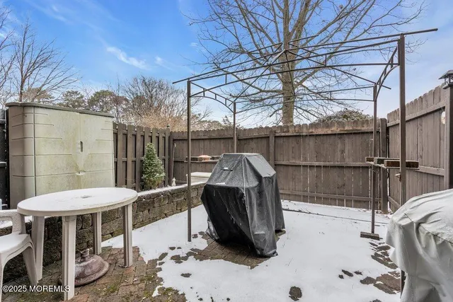 a view of a patio with table and chairs with wooden fence and floor