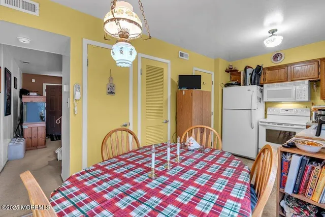 a bedroom with a bed and a large mirror on the dresser