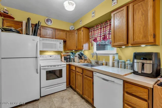 a kitchen with stainless steel appliances a stove a sink and a refrigerator