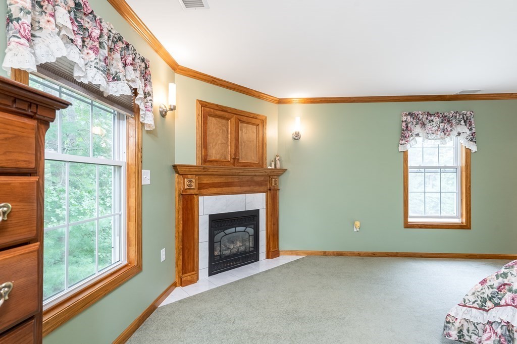 58 Autumn Road Dracut, MA 01826 - Photo 30 of 35 a view of an empty room with a fireplace and a window