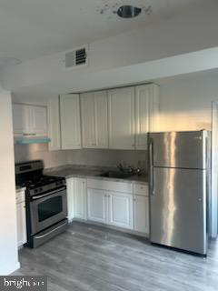 454 Roundview Road Baltimore, MD 21225 - Photo 11 of 12 KItchen has new cabinets.Stainless Steel Apliances