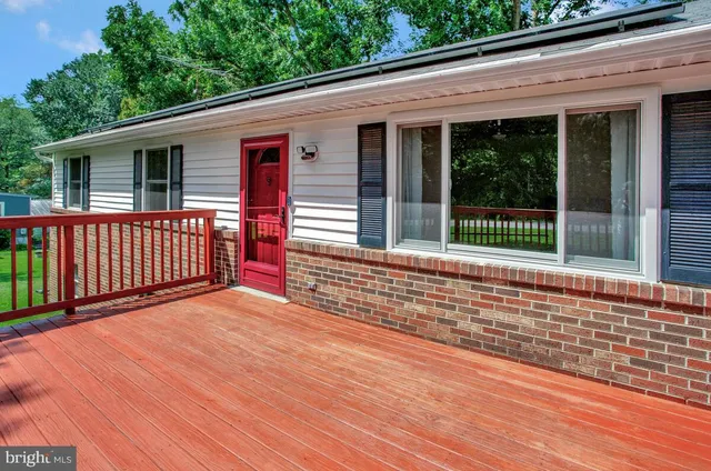 a view of backyard with deck and outdoor space