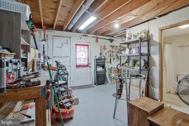 a view of deck with furniture and umbrella
