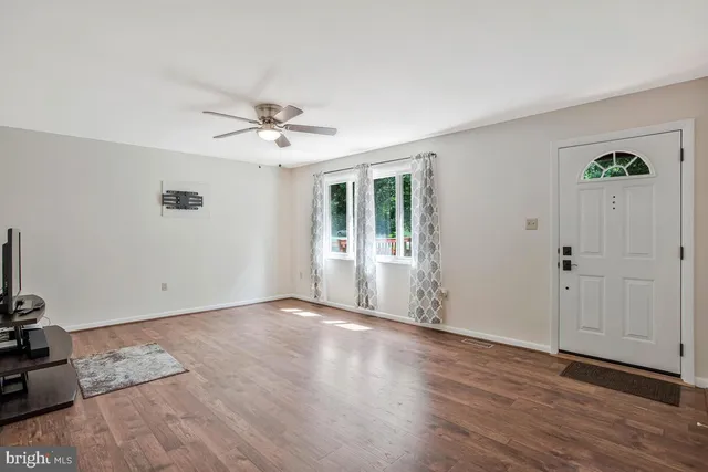 wooden floor in an empty room with a window