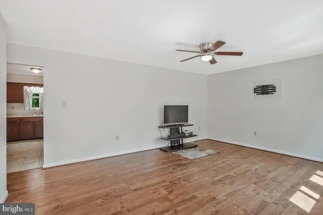 a view of workspace with wooden floor and a ceiling fan