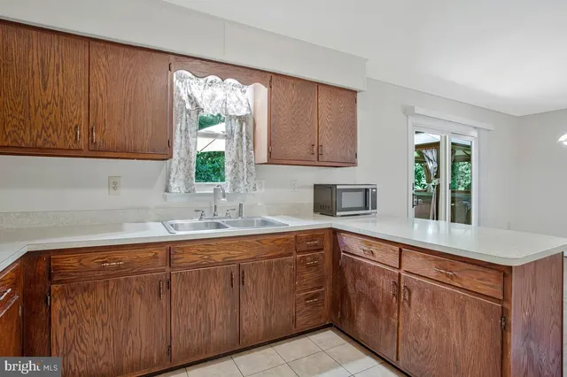 a kitchen with sink cabinets and window